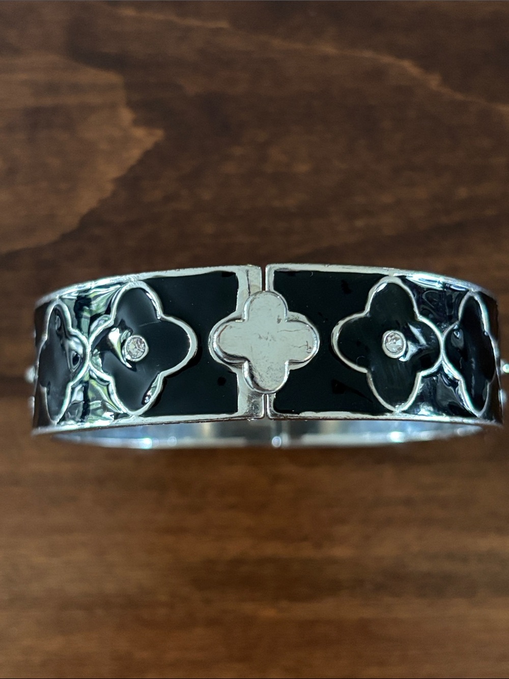 🍀3 for $25🍀 Silver tone hinged bangle features a striking black enamel inlay